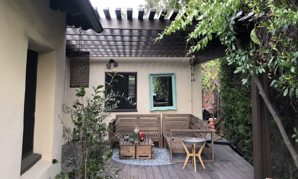 wooden pergola complimenting a backyard deck