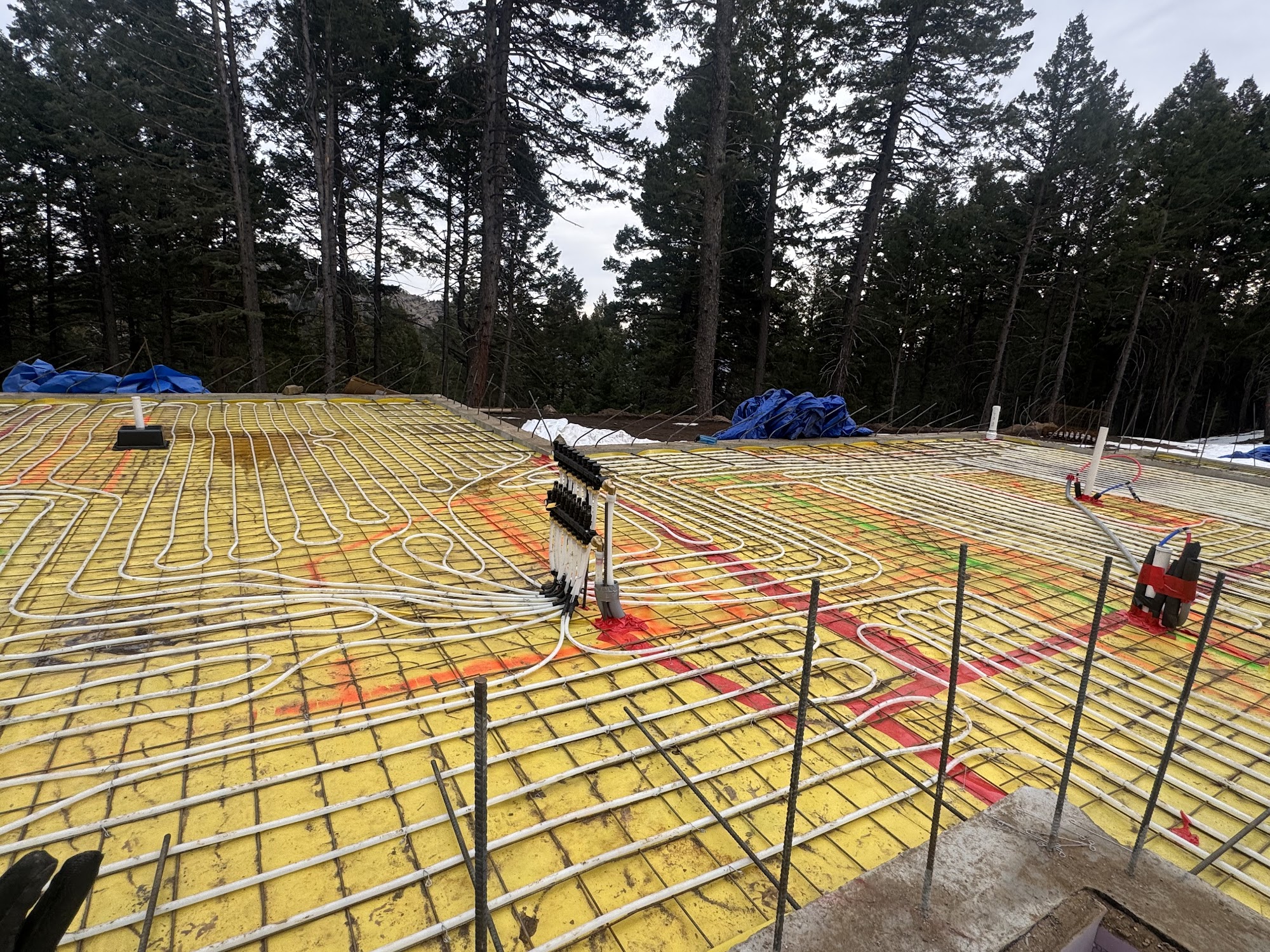 Radiant in-floor heating tubes installed on a Colorado custom home slab, typical pairing with high-performance ICF walls