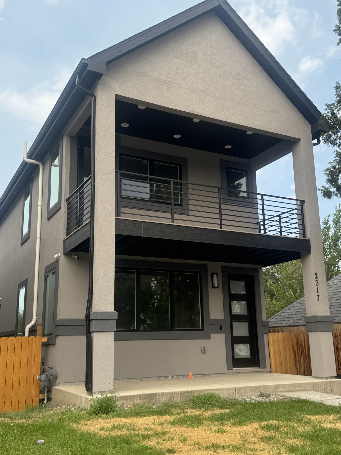 Custom two-story stucco home with covered balcony built by Vertical Contracting on Colorado's Front Range