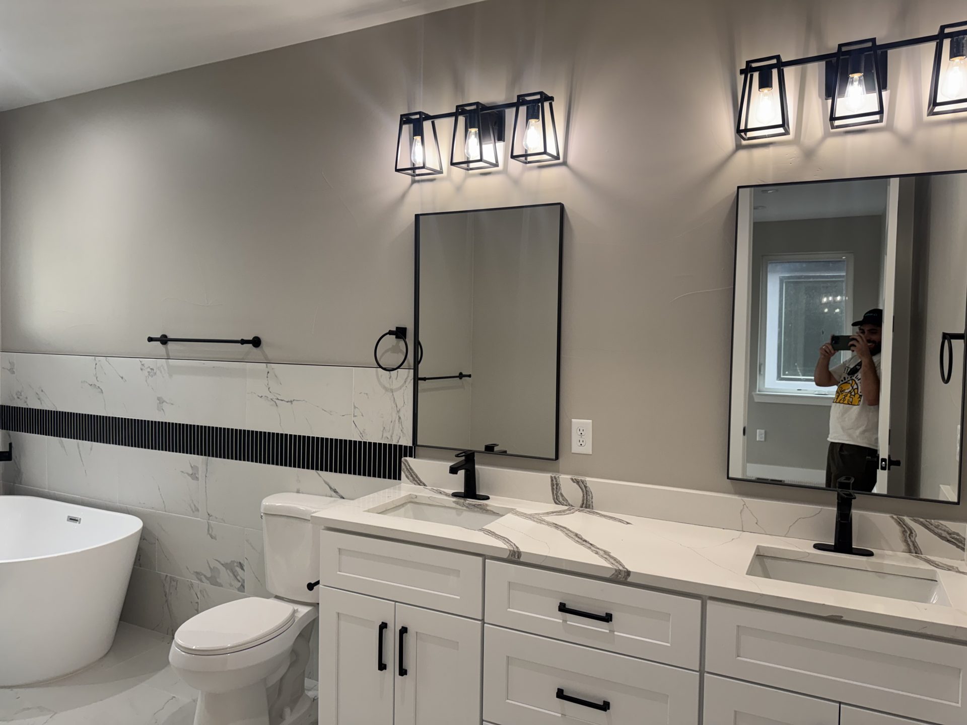 Primary bathroom with double vanity and freestanding tub in a custom Front Range home