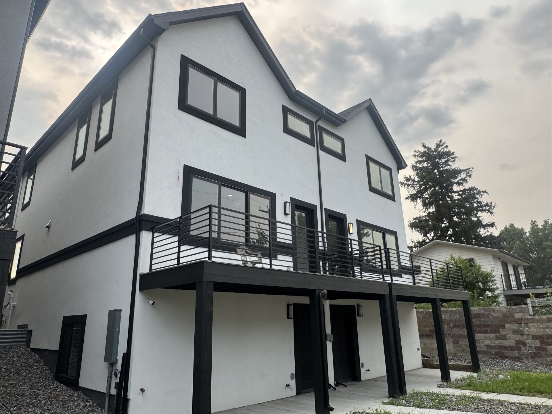 Rear view of custom Front Range homes with balconies and walkout lower level